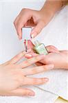applying manicure: moisturizing the nails and skin around