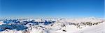 Panoramic view of the French Alps under snow with a great blue sky