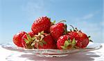 Red Strawberrys heap on the blue sky background