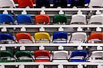 Several rows of multi-coloured plastic stadium seats