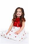 Pretty little girl in red and white christmas or valentine's day dress.