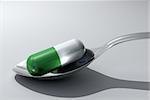 Pill in spoon - extreme close up - 3d render