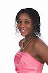Bust style portrait of a pretty African American teenage girl wearing a pink strapless gown and a rhinestone necklace, against a white background.