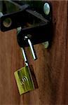 an open padlock in a bolt, opening a door