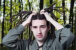 Young man with dreadlock hair keeps for a head.