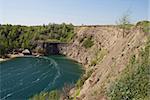 deep lake near rocks and tree