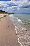 empty beach under cloudy sky