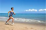 Young woman running alone on the beach