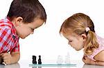 Serious kids playing chess - isolated