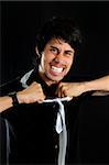 Portrait of young hispanic businessman with crazy expression