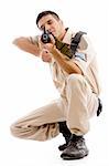 sitting soldier going to shoot with gun on an isolated background