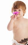 Portrait of a baby girl smelling  a flower