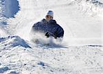 man braking while sledding fast down the hilll with snow background