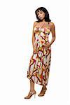 Full body of an attractive brunette woman wearing long print summer dress over white
