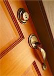 Brass door handle and deadbolt on wooden door