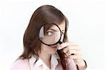 Young Woman holding Magnifying Glass