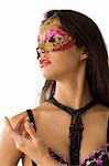 close up of young pretty woman with long black hair and carnival mask