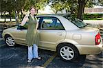 Sixteen year old girl holding the keys to her first car.