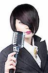 Young woman with fashion haircut holding a vintage microphone, on white
