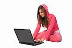 Young beautiful woman in the pink sportswear sitting with her laptop over white background