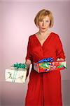 attractive older woman in red dress holding gifts