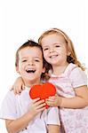 Happy children with red heart shaped box hugging and laughing - isolated