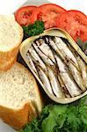 Sardines with bread, red onion, tomato and lettuce.