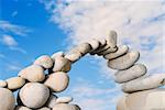 Sea pebble combined in the form of the bridge against the sky