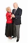Beautiful senior couple dressed up and dancing together.  Full body isolated on white.