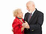 Loving seniors couple out dancing together.  Isolated on white background