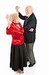 Senior couple having a great time dancing together.  Full body isolated on white.