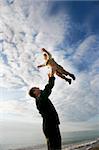 father and son playing on beach