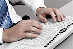 Man typing on a computer keyboard