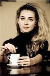 Portrait of beautiful young woman drinking coffee