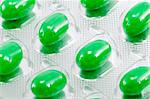 green oval medical pills in their packages