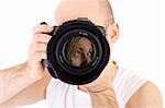 a photographer pointing his camera on a female model (reflexion in lens) isolated on white