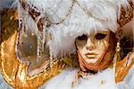 Carnival in venice with model dressed in various costumes and masks - gold lady