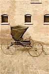 An old horse-drawn carriage done in sepia.