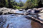 Lake and waterfall cascades in mountains among huge stones and jungle forest