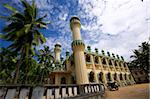 Antique islamic mosque in the green palms on the beach