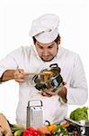 young chef preparing lunch on white background