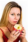 Long hair blonde woman in red with  apple in her mouth