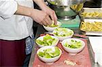 A chef and his sous-chef working in a kitchen