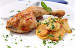 grilled chicken leg with potato and parsley