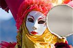 Carnival in venice with model dressed in various costumes and masks - orange lady
