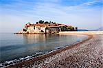 Sveti Stefan island in Budva, Montenegro.  Silent morning with beautiful  azure sky