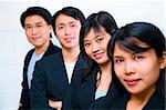 Young Asian business people line up, with focus on the second front woman (Chinese woman)