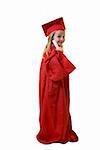 Cute little eight year old wearing red graduation cap and gown holding a diploma standing on white