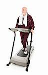 Fit senior man works out on a treadmill.  Full body on white.