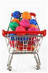 Colorful easter eggs in a shopping trolley on white background